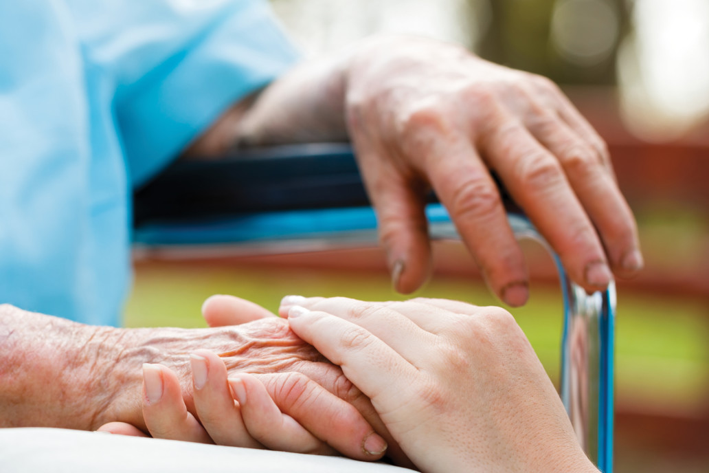 elderly man and nurse holding hands geriatric our clients Endless Journey Hospice Omaha Nebraska