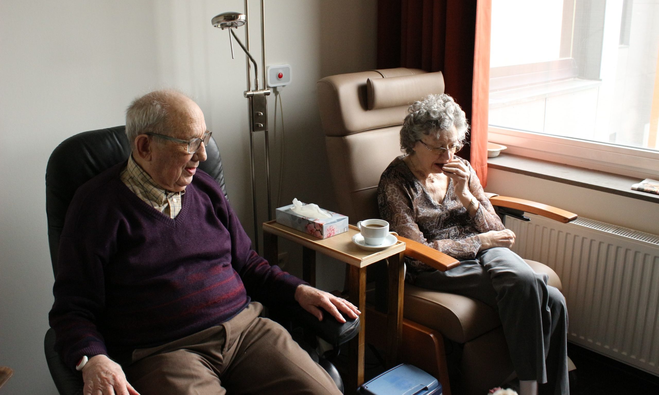 elderly couple sitting by window geriatric our clients Endless Journey Hospice Omaha Nebraska